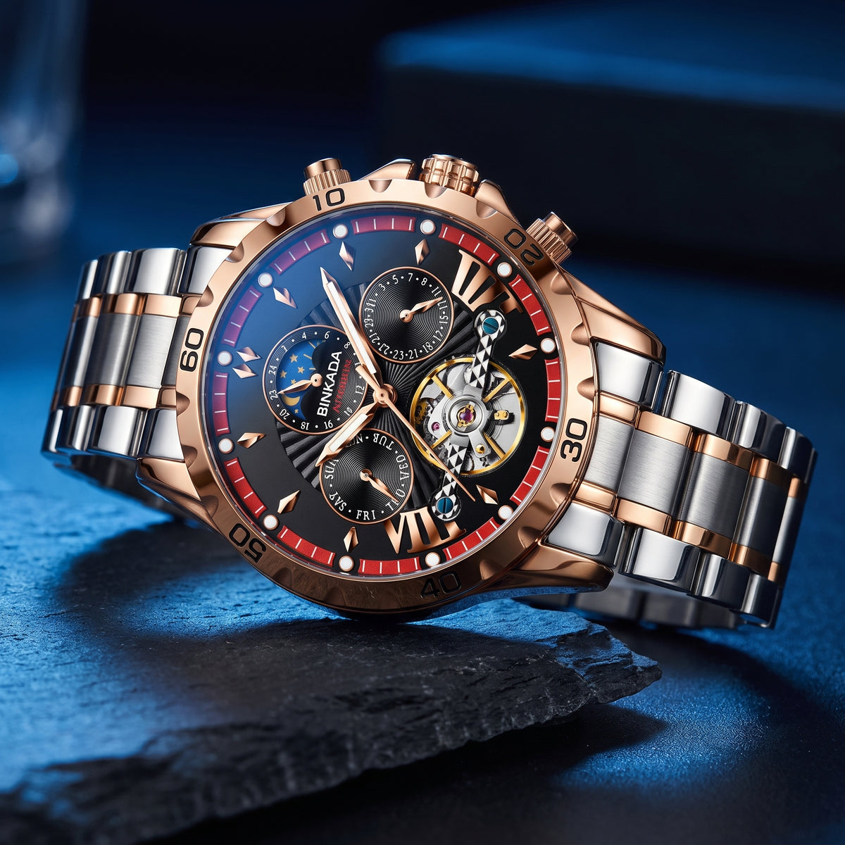 A luxury men's chronograph watch with a two-tone rose gold and stainless steel link bracelet, featuring a black dial with red accents and a visible mechanical movement through an open case.