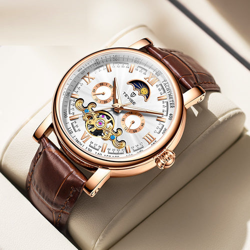 Luxury watch with brown leather strap and rose gold case on a light background