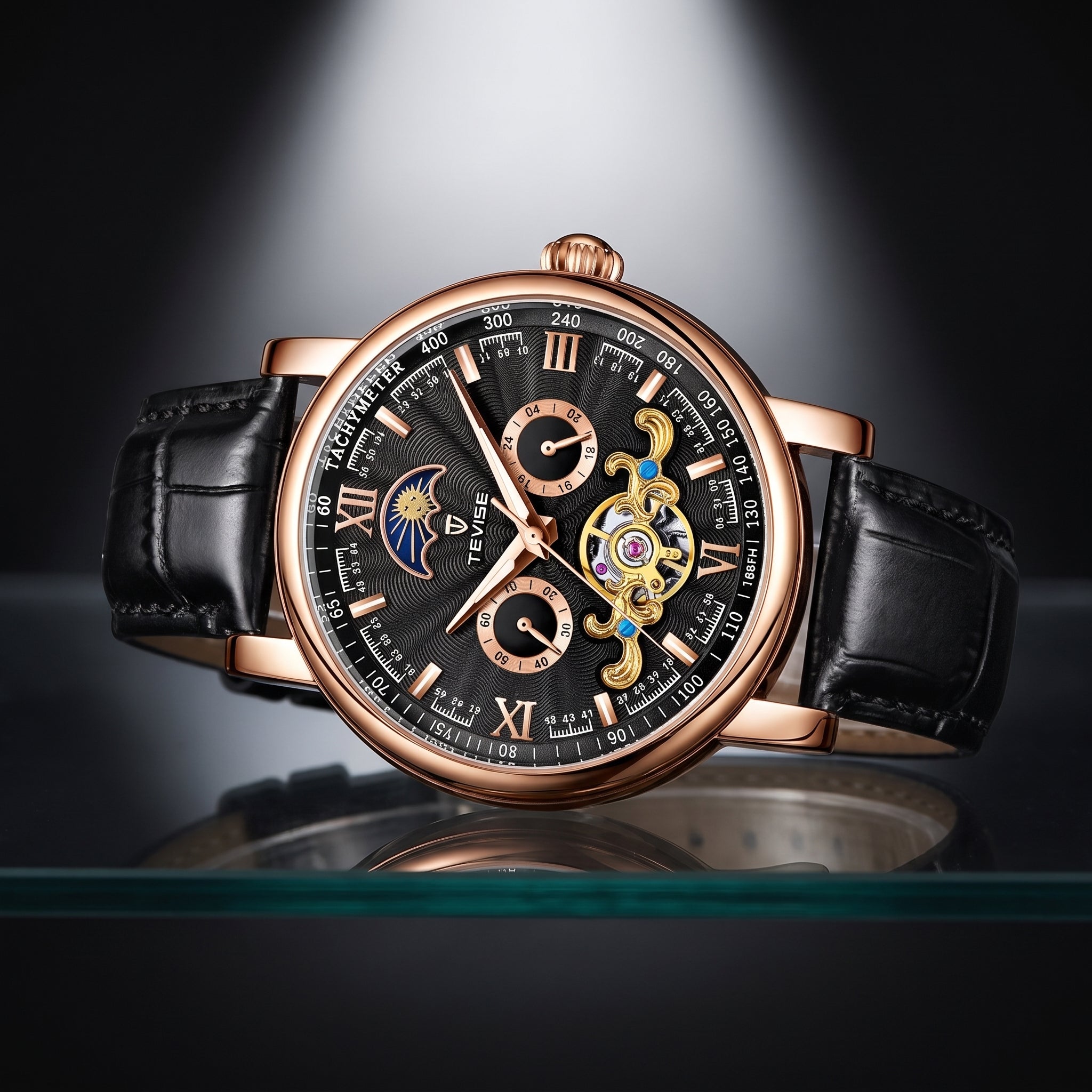 A luxury wristwatch with a black leather strap, rose gold case, and a detailed black dial featuring Roman numerals, sub-dials, and a visible gold-toned mechanical movement through an open-heart design.