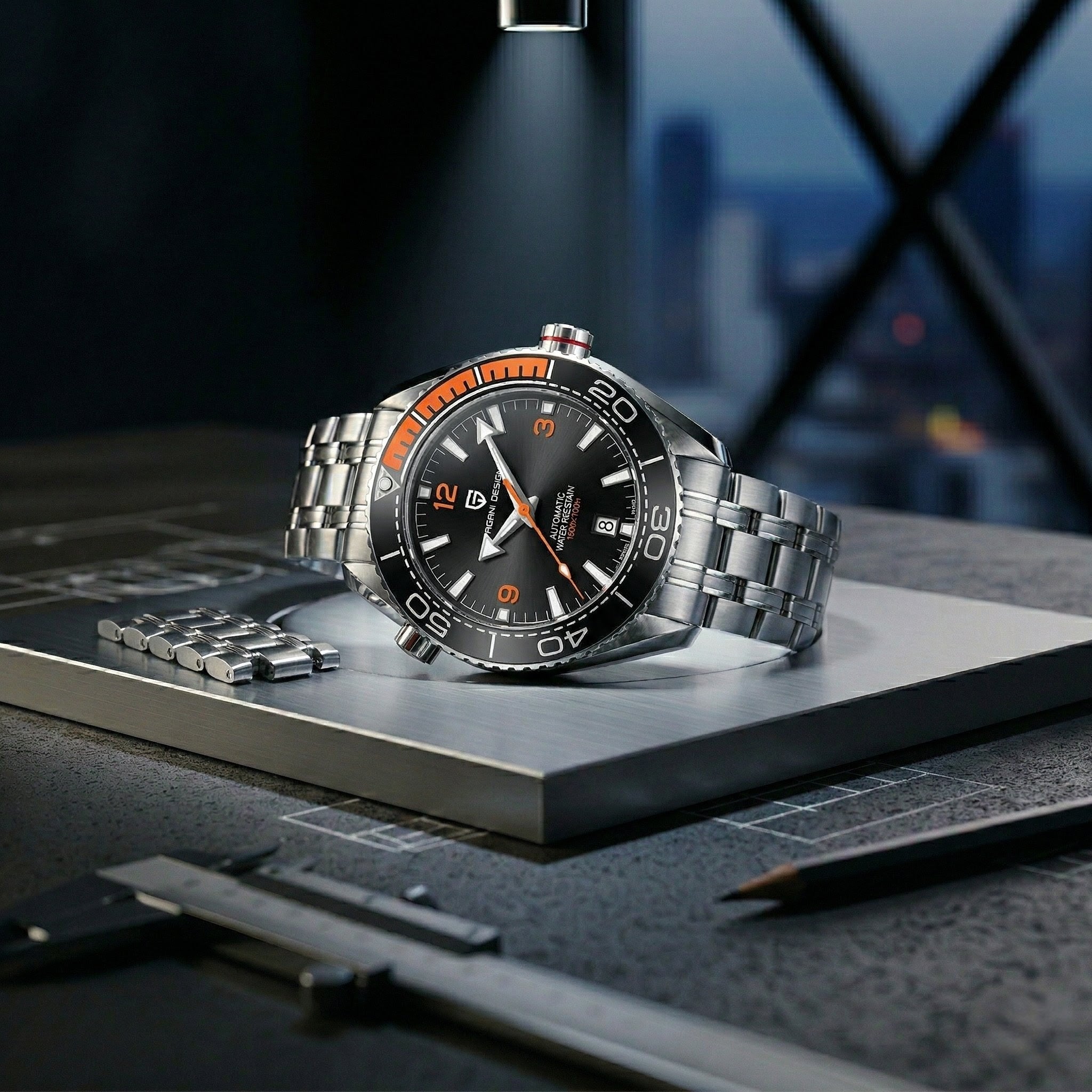 Luxury watch with a black face and silver metal strap on a dark surface with blurred cityscape background