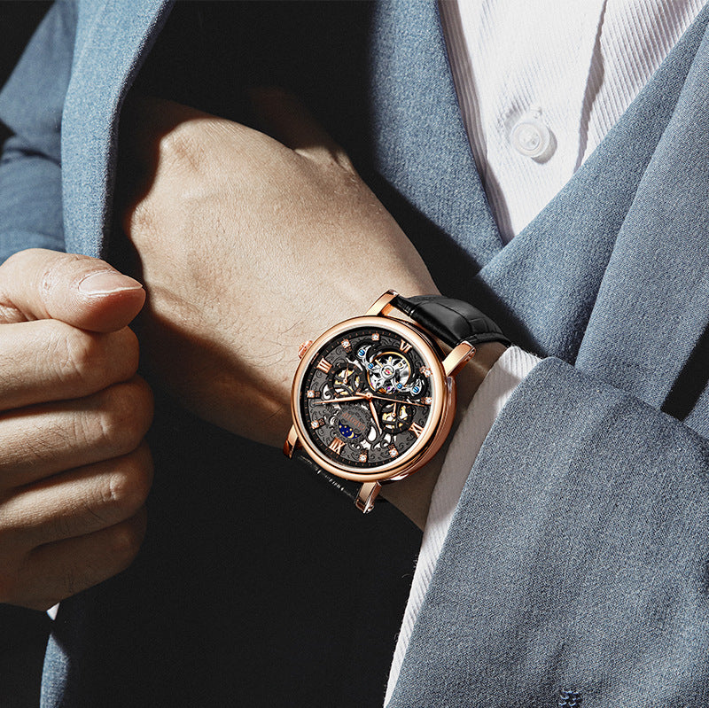 Close-up of a person wearing a rose gold watch with a dark strap.
